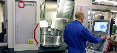 An engineer working on a Hermle CNC Machine