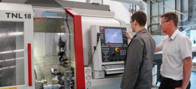 A machined metal part in the shape of a women with wings