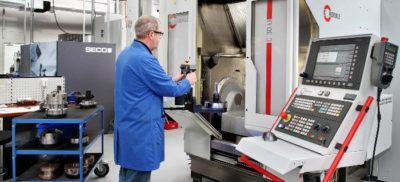 An engineer working with a Hermle CNC machine