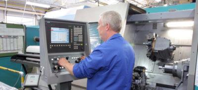 An engineer working on a CNC Machine
