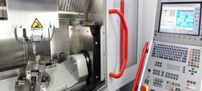 The control panel and inside view of a CNC machine