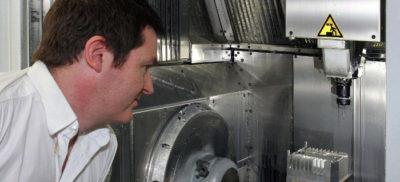 An engineer looking into a CNC machine