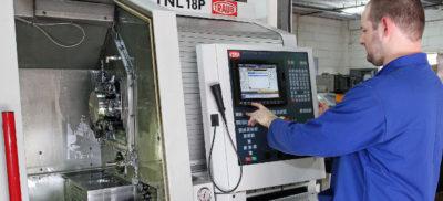 An engineer programming a CNC machine