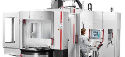 An engineer working next to a Hermle machine