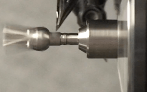 A metal component being machined close-up