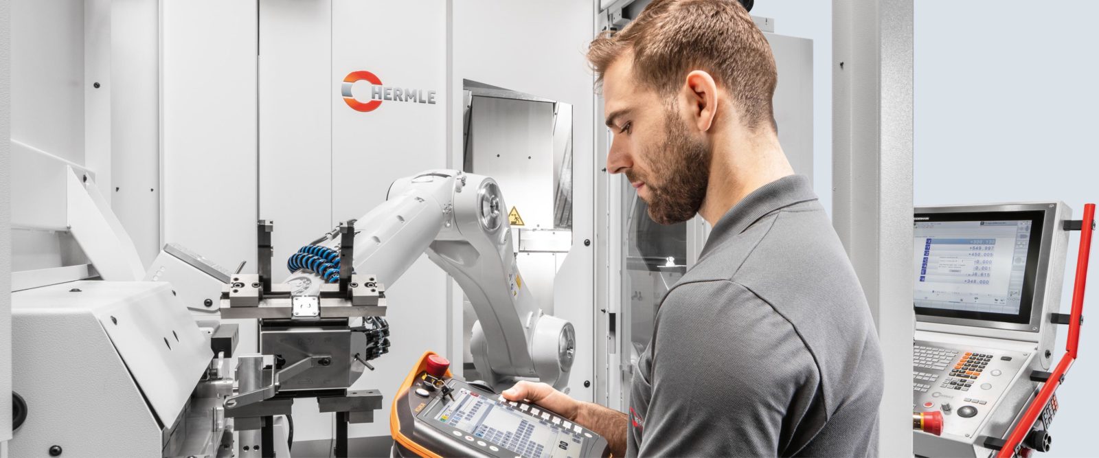 technician operating automated robotic arm