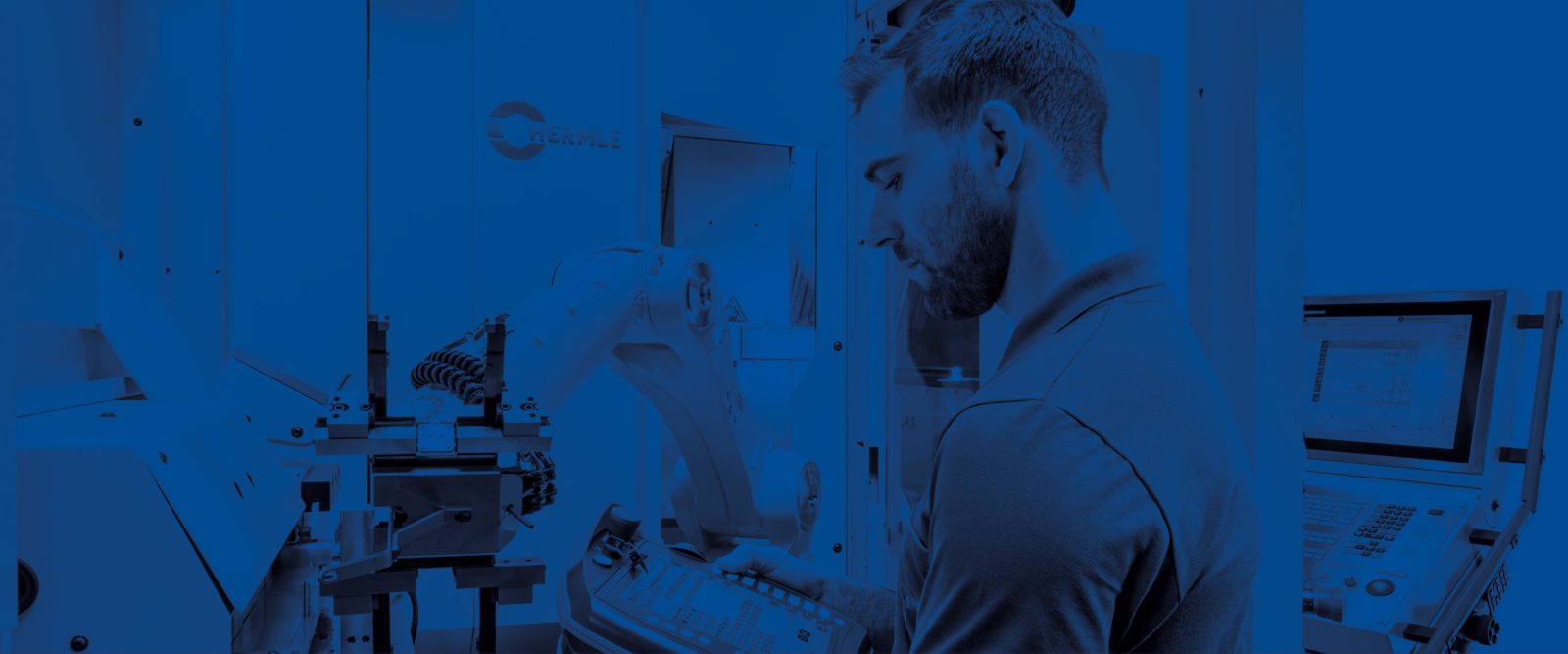 technician operating automated robotic arm