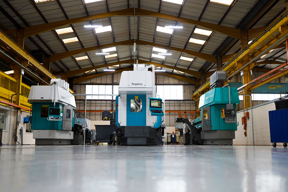 Three CNC machines in a warehouse