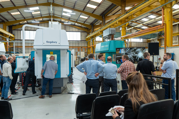 A crowd of people looking at machines and talking after a seminar