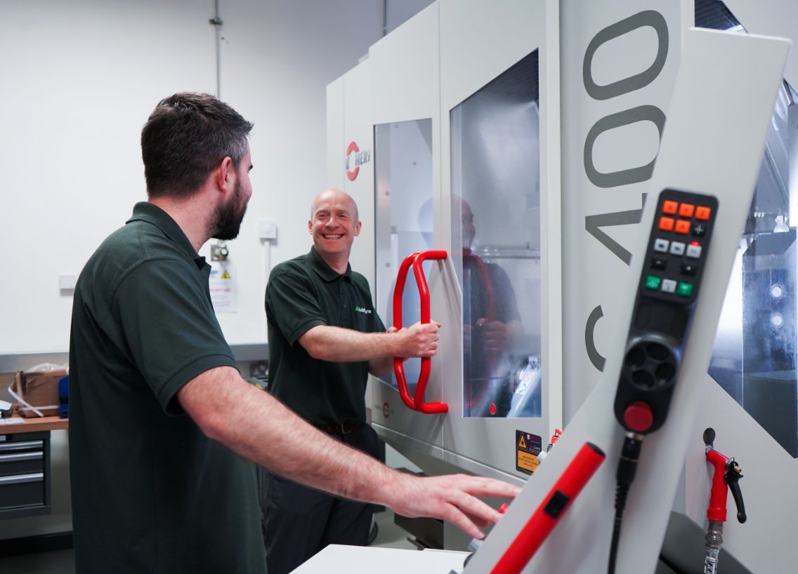 two guys operating a cnc machine