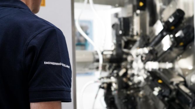 kingsbury employee with machine in background