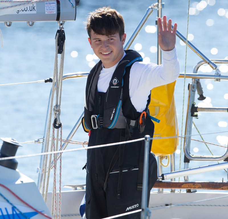 Tim Long on his sail boat waving