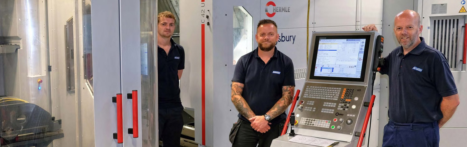 Engineers next to a Hermle machine