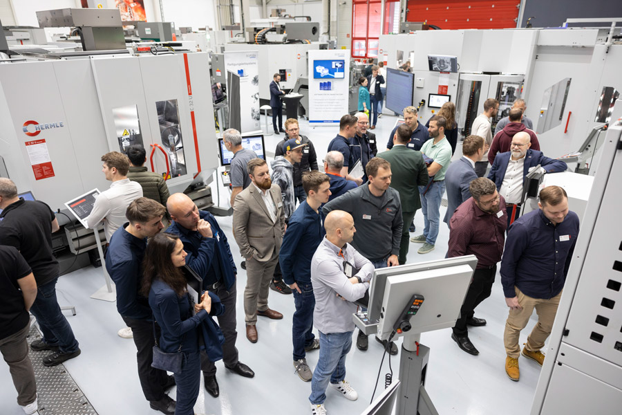 Hermle open house event with attendees looking at machines