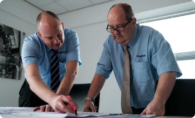 Two Kingsbury employees reviewing paperwork