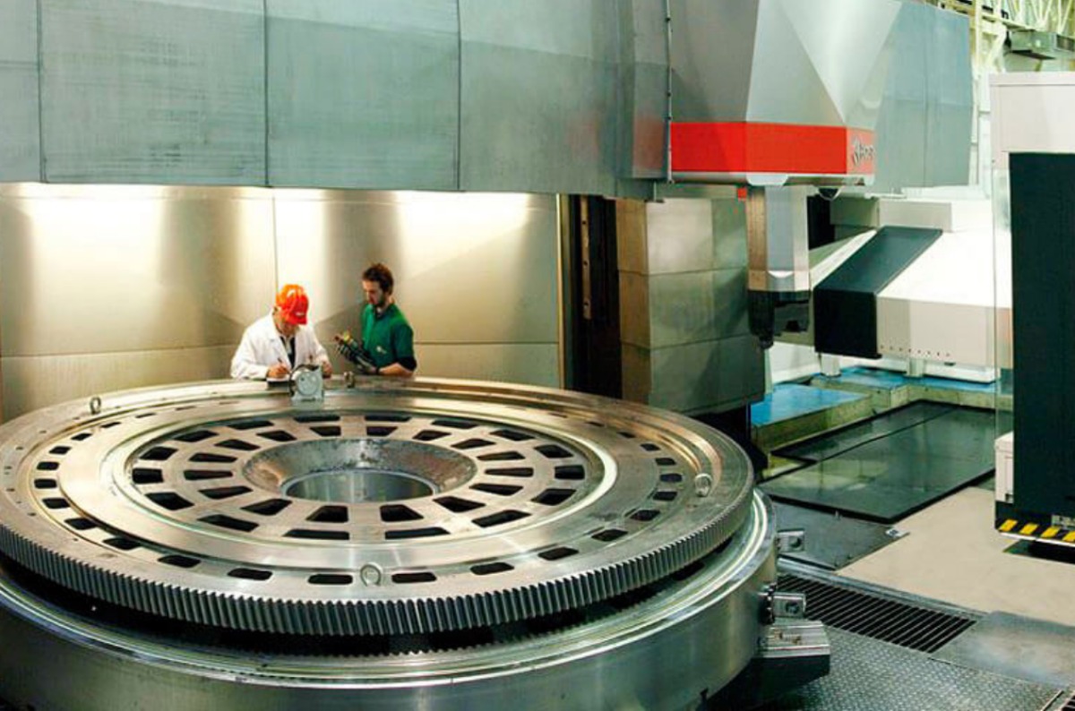 Bost CNC machine with engineers next to it