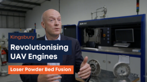 Thumbnail image showing a screenshot from the video, of a man talking to the camera, in front of the machine