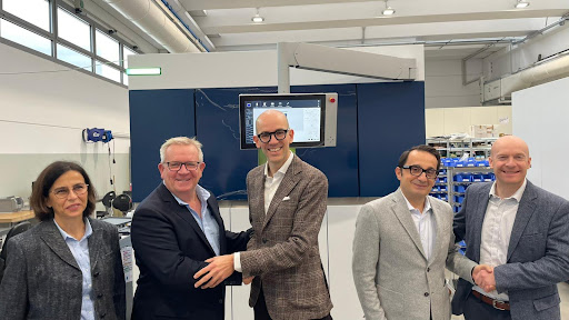 Richard Kingsbury and members of ATLIX in a machining warehouse