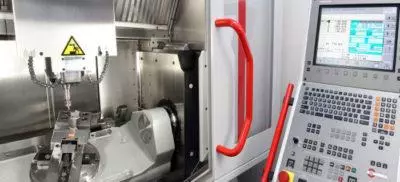 The control panel and inside view of a CNC machine