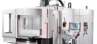 An engineer working next to a Hermle machine