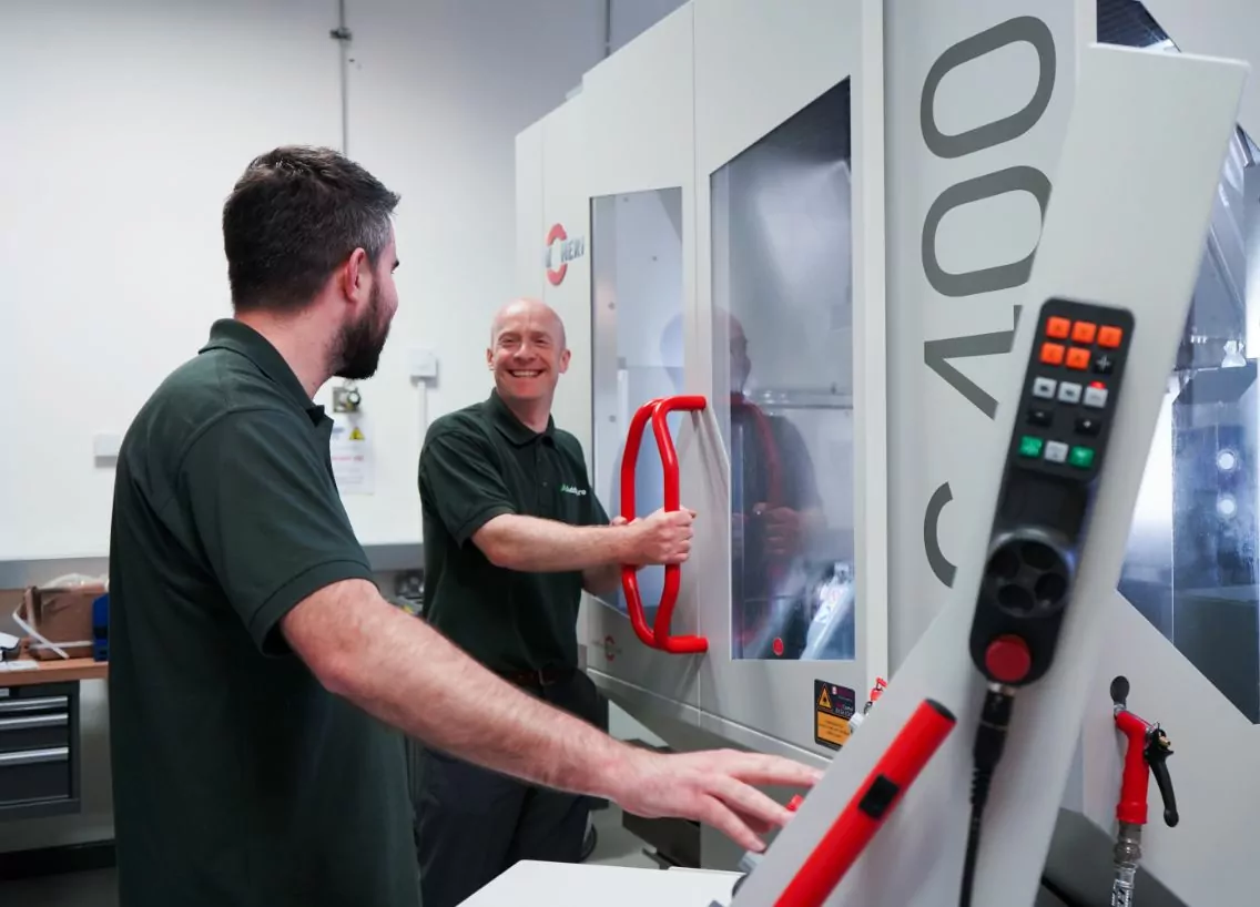 two guys operating a cnc machine