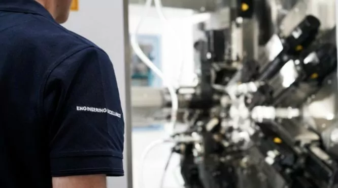 kingsbury employee with machine in background