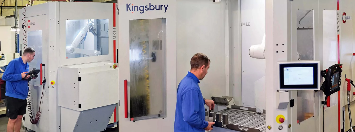 Engineers next to a Hermle machine