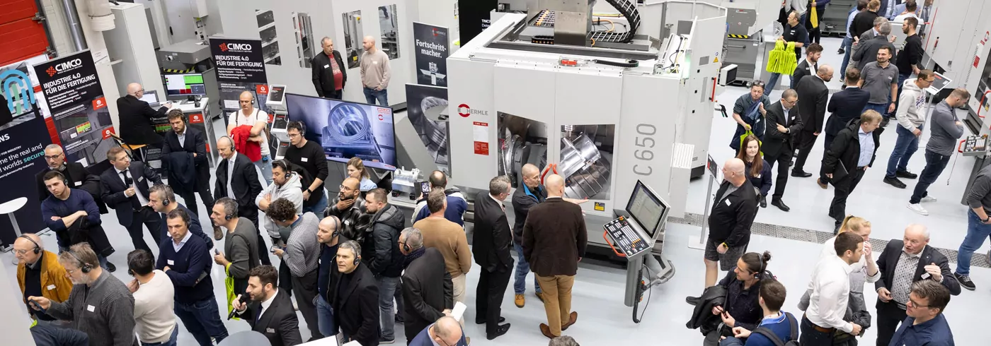 Hermle open house event with attendees looking at machines